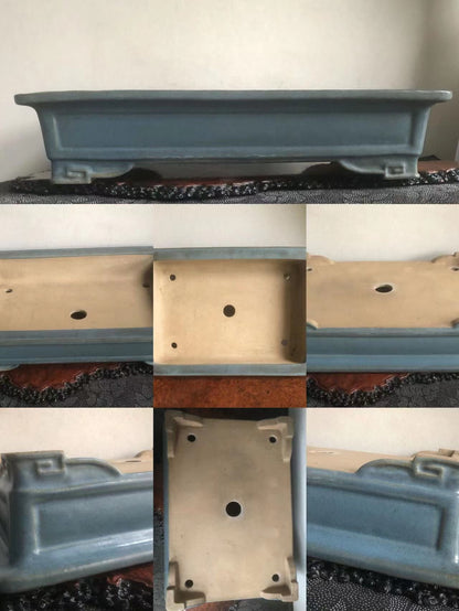A rectangular blue glazed pot with a light beige interior and four feet.