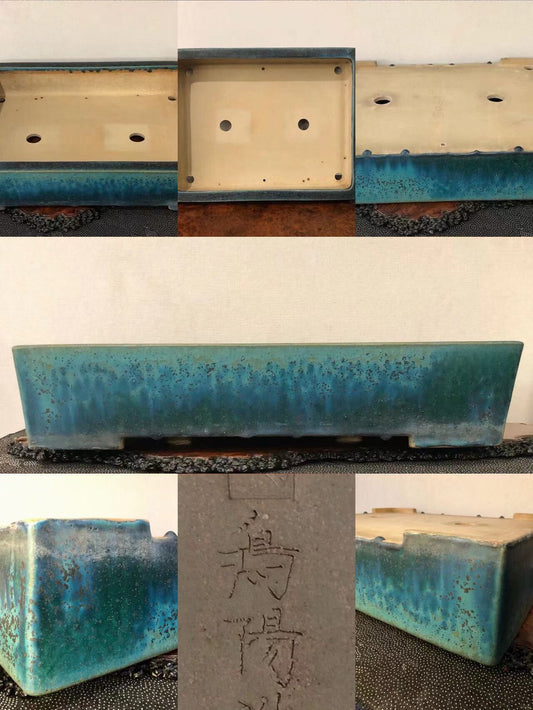 Rectangular glazed pot with mottled blue-green glaze and carved characters on its base.