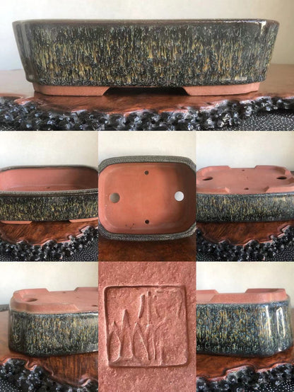 Rectangular glazed pot with speckled dark grey and gold glaze, unglazed terracotta interior, and carved square mark.