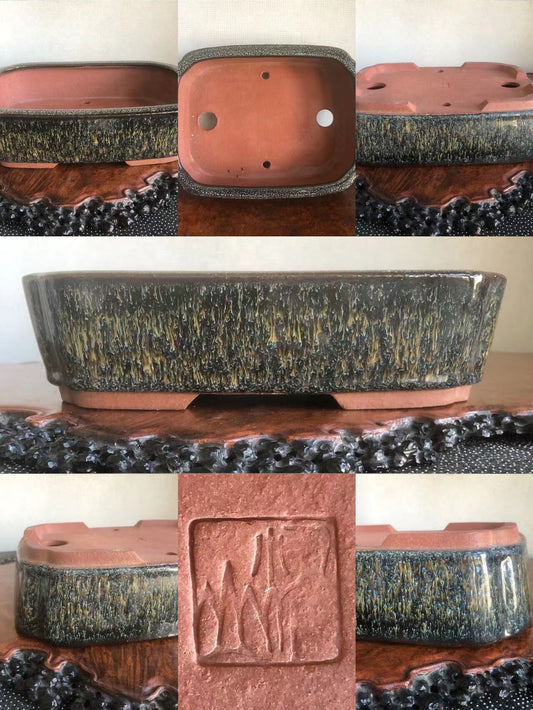 Rectangular glazed pot with speckled dark grey and gold glaze, unglazed terracotta interior, and carved square mark.
