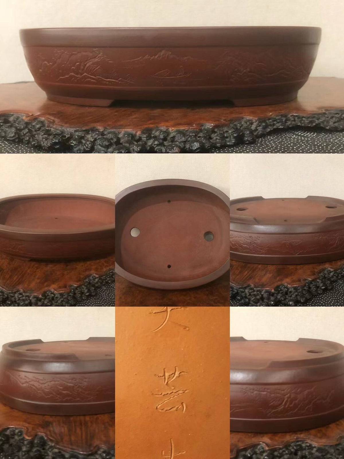 A dark brown glazed ceramic bonsai pot with carved mountain scenes and three drainage holes.