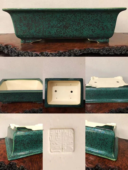 Rectangular green glazed pot with speckled finish and white interior, showing base seal.