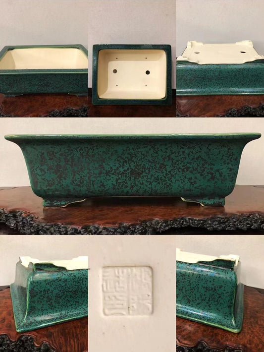 Rectangular green glazed pot with speckled finish and white interior, showing base seal.