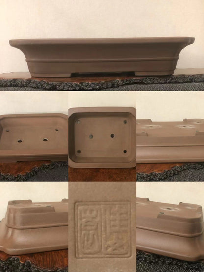 A brown unglazed rectangular bonsai pot with a stamped square mark on its base.