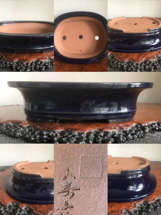 Dark blue glazed pot with three drainage holes and a square maker's mark on the base.