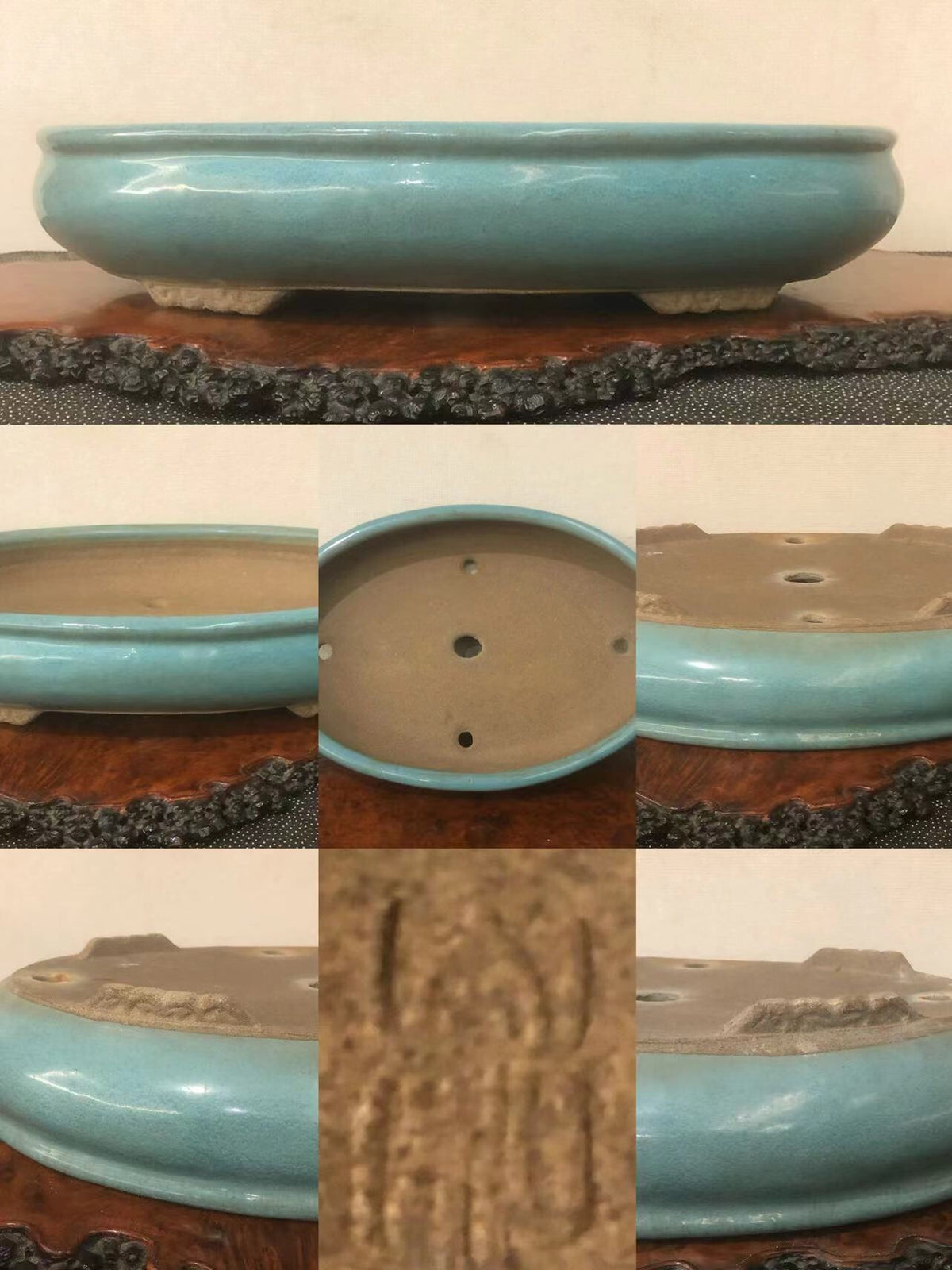 A glossy turquoise glazed pot with three drainage holes and a carved mark on its base.