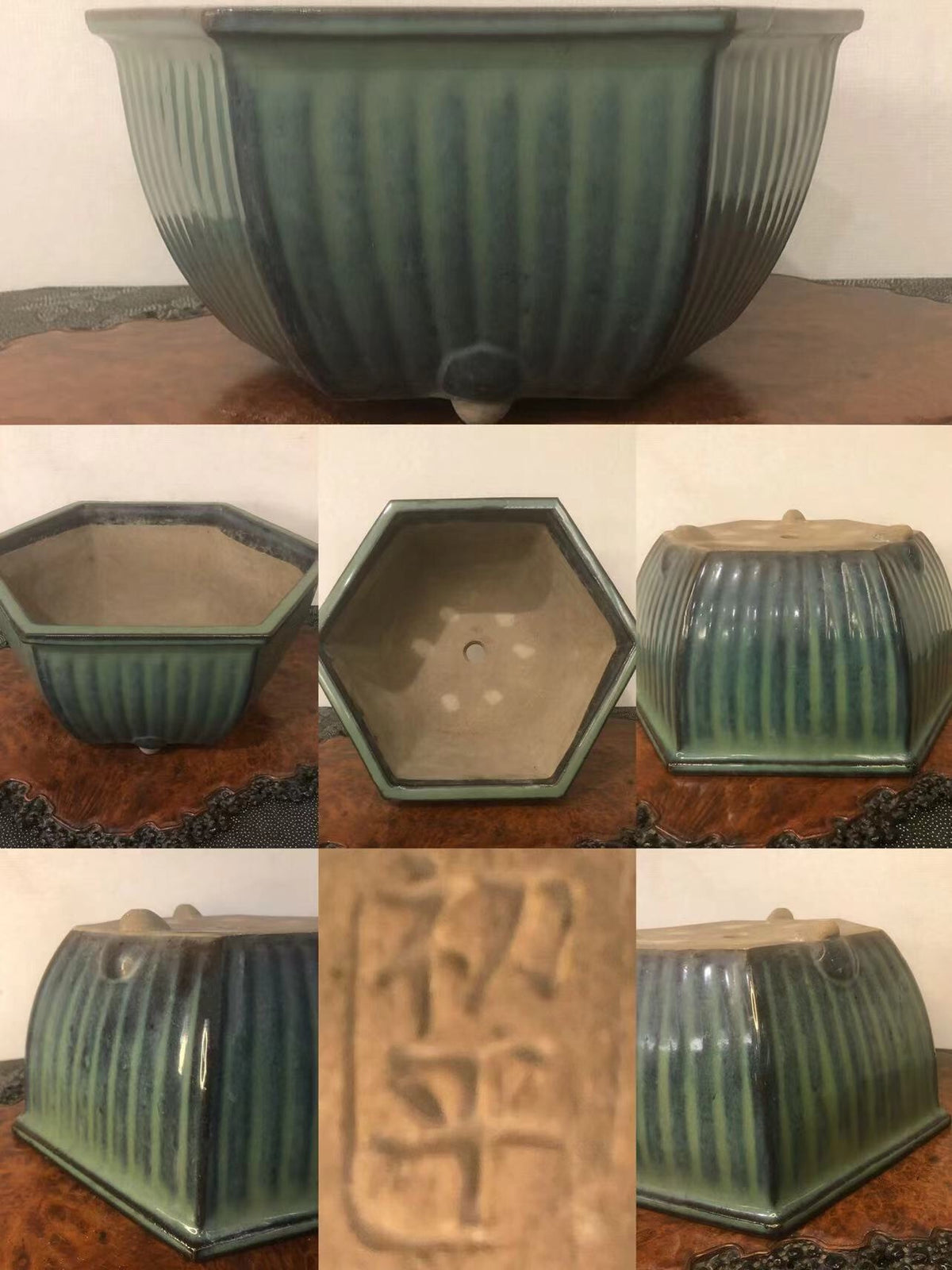 A hexagonal glazed pot with vertical ridges and a stamped character on its base.