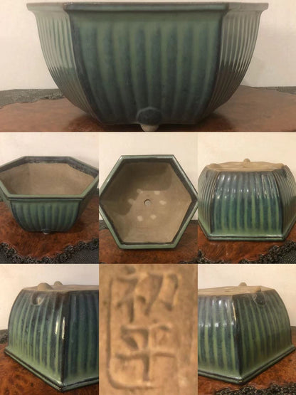 A hexagonal glazed pot with vertical ridges and a stamped character on its base.