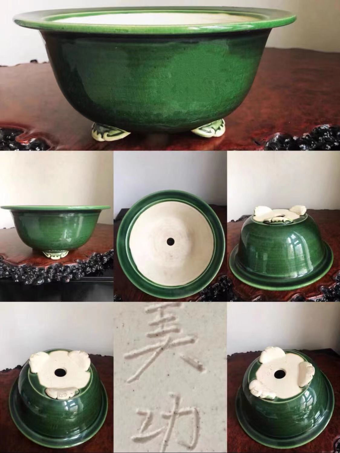 Dark green glazed pot with white floral decoration and three feet, showing interior and base markings.