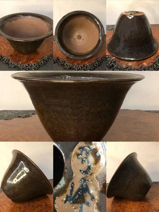 Dark brown glazed ceramic pot, wide rim, glossy finish, with blue and white speckled glaze on interior.