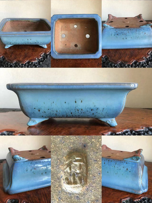 Light blue glazed rectangular pot with speckles, four feet, and an impressed seal.