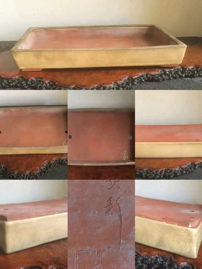 Rectangular glazed terracotta bonsai pot with gold rim and incised characters on side.