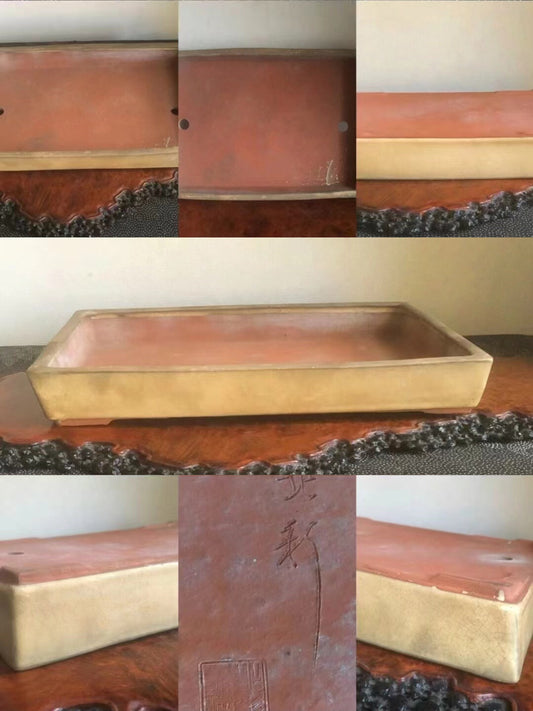 Rectangular glazed terracotta bonsai pot with gold rim and incised characters on side.