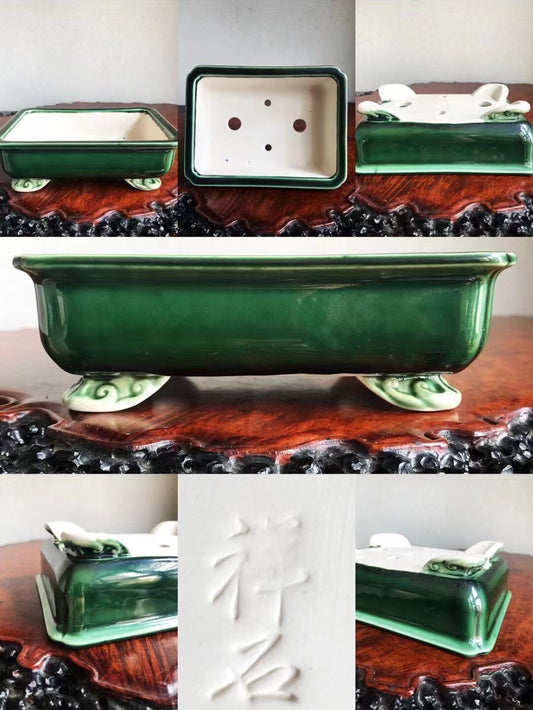 Dark green glazed rectangular pot with white footed base and carved character mark.