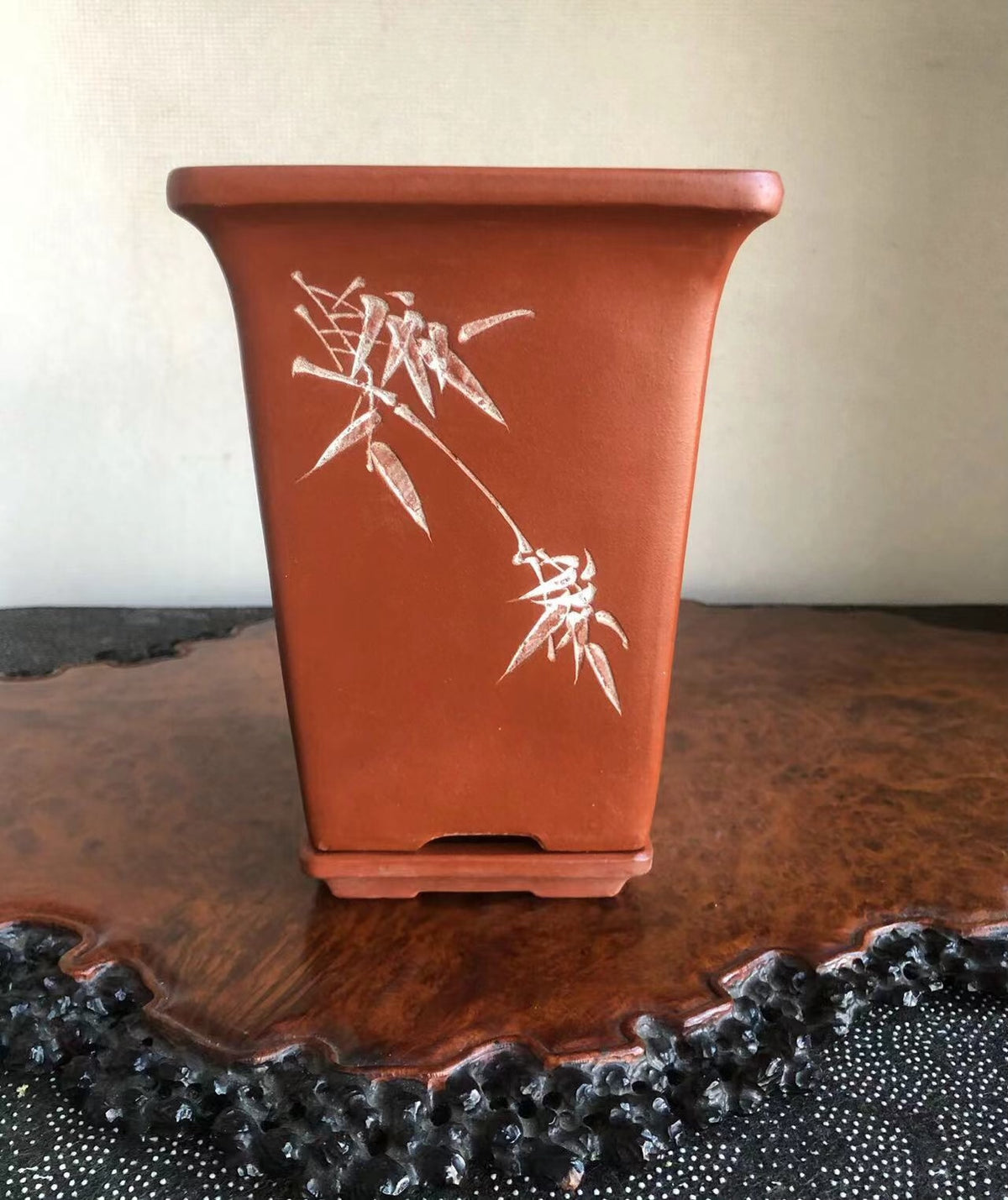 Rectangular terracotta pot with white bamboo motif, matte finish, sits on wooden tray.