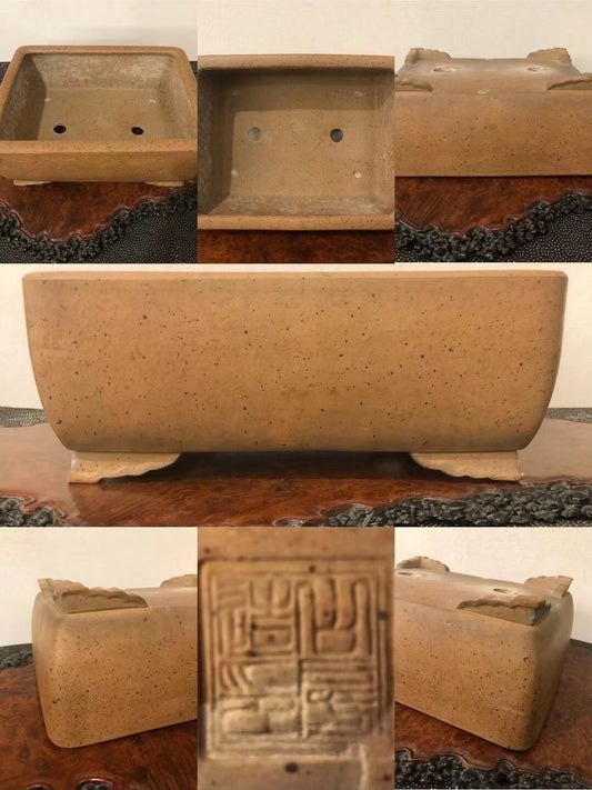 Rectangular terracotta pot with speckled matte finish and carved seal mark on base.