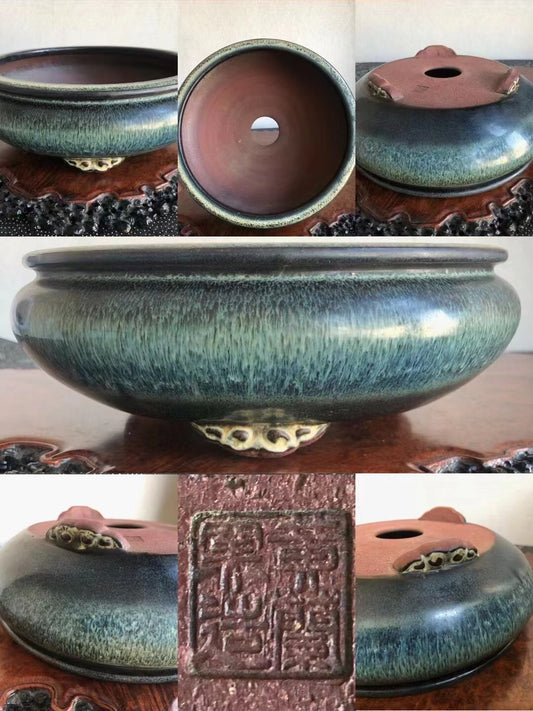 A glazed ceramic pot with a mottled green and blue glaze, a footed base, and a square seal impression.