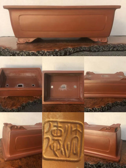 Rectangular terracotta pot with footed base, glazed reddish-brown surface, and raised seal mark.