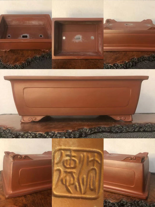 Rectangular terracotta pot with footed base, glazed reddish-brown surface, and raised seal mark.