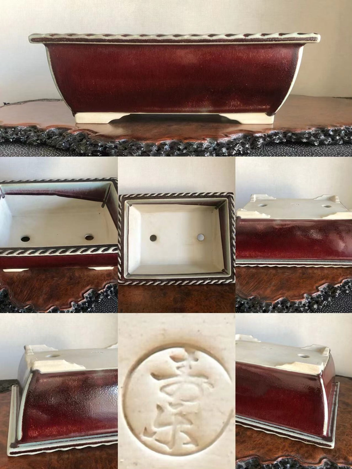 A rectangular bonsai pot with a glossy deep red glaze and a white interior, featuring a raised circular mark with characters.