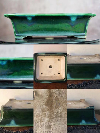 A rectangular glazed pot with a vibrant green glaze and subtle blue speckles, showing an engraved mark on its base.