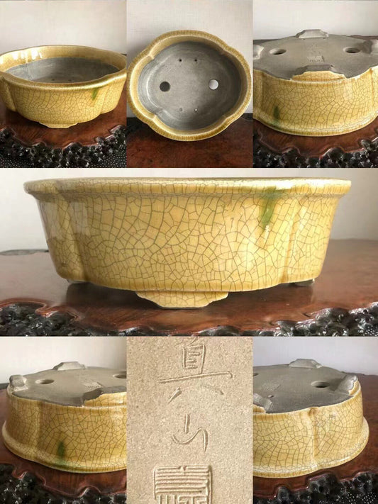 Yellow glazed pot with crackled surface, five lobed shape, and carved characters on base.