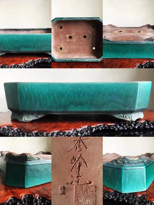 A teal glazed rectangular pot with carved feet and an engraved signature on its base.