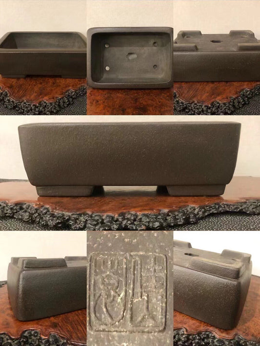 Dark grey rectangular pot with textured matte finish and carved seal on base.