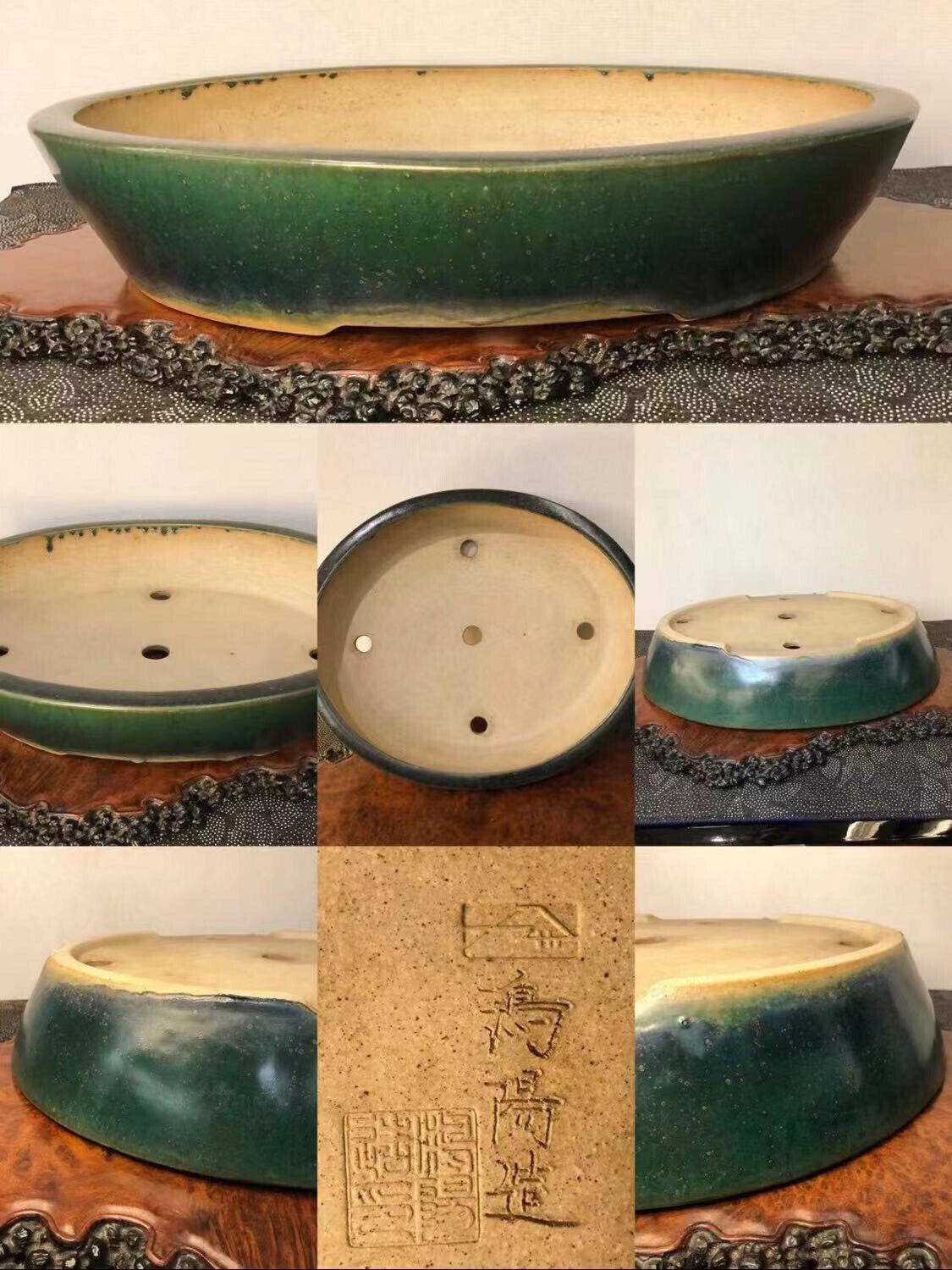 Oval glazed pot, dark green outside, beige inside, with three drainage holes and a maker's mark.