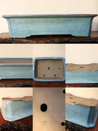 Rectangular blue glazed pot with speckled finish and drainage holes, unglazed underside.
