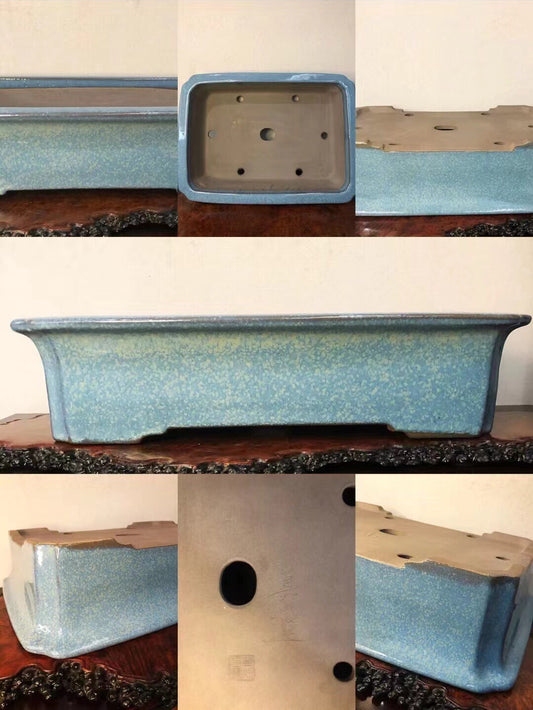 Rectangular blue glazed pot with speckled finish and drainage holes, unglazed underside.