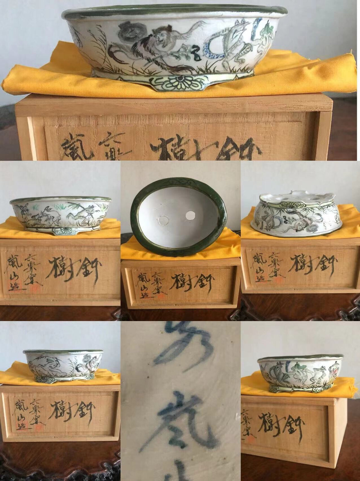 A white glazed pot with green rim, painted with dragons and clouds, sits on a wooden box.