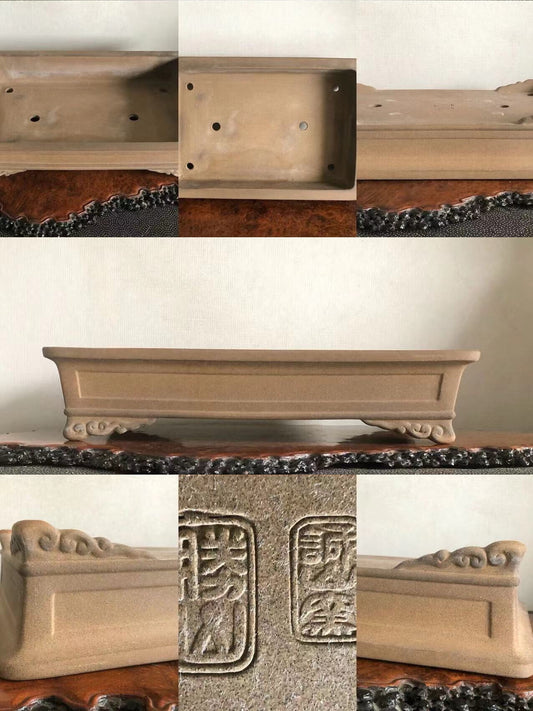 Rectangular beige ceramic pot with carved feet and two square maker’s marks on base.