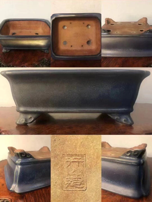 Dark blue glazed rectangular pot with four feet and a square base with four holes.