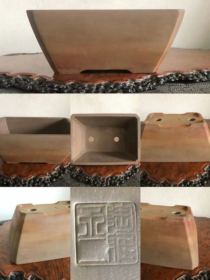 A matte brown rectangular pot with a stamped square mark on its base.