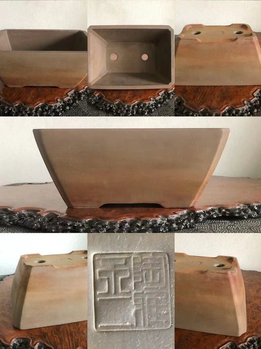 A matte brown rectangular pot with a stamped square mark on its base.