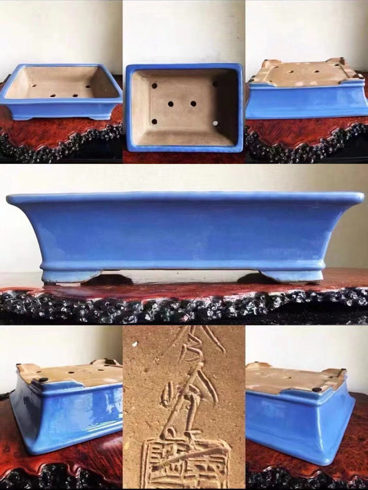A rectangular blue glazed pot with a carved signature on its unglazed base.
