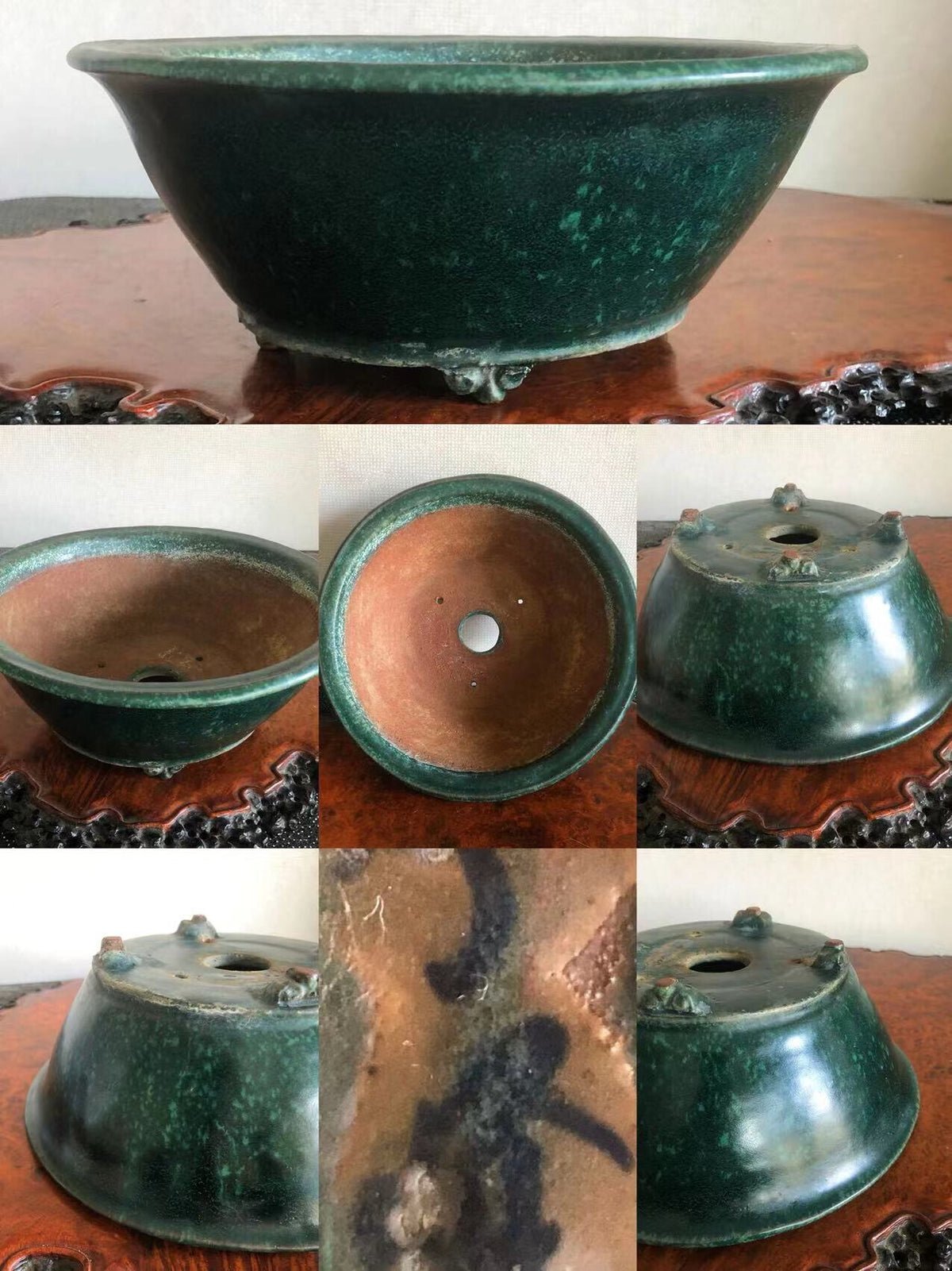Dark green glazed pot with three feet, showing interior and base markings.