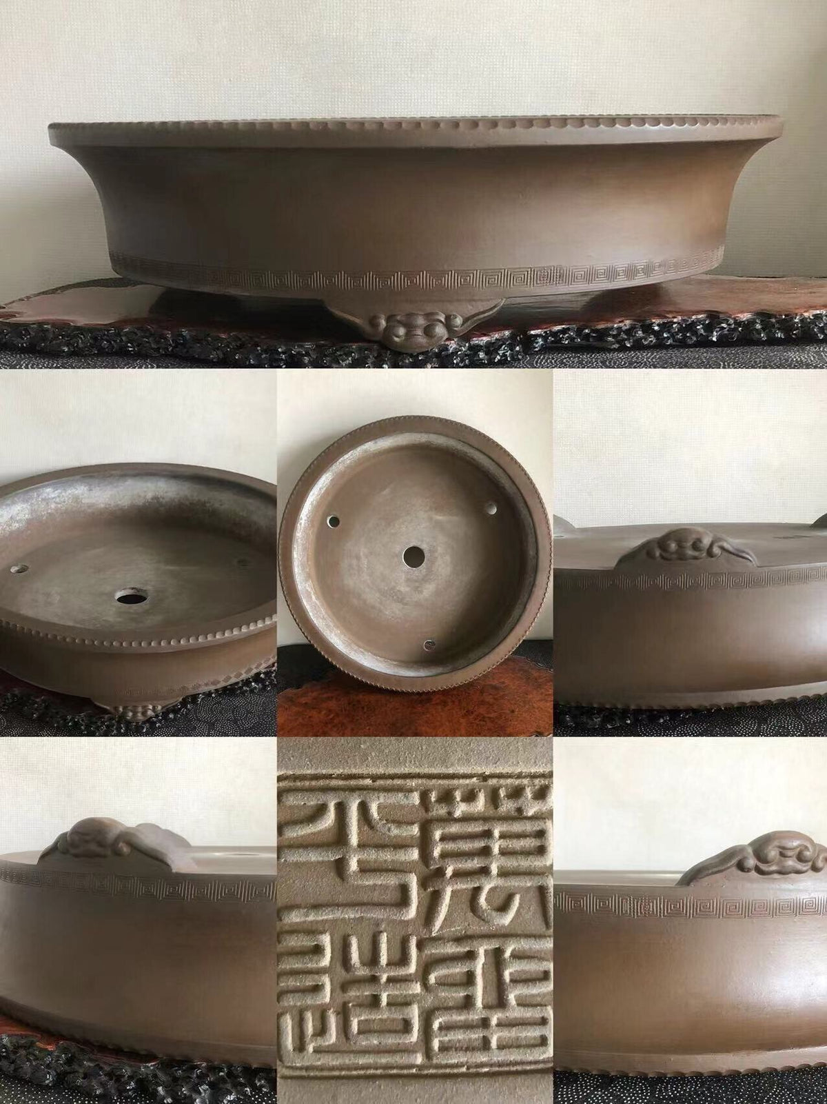A brown glazed ceramic bonsai pot with carved dragon motifs and a raised rim.
