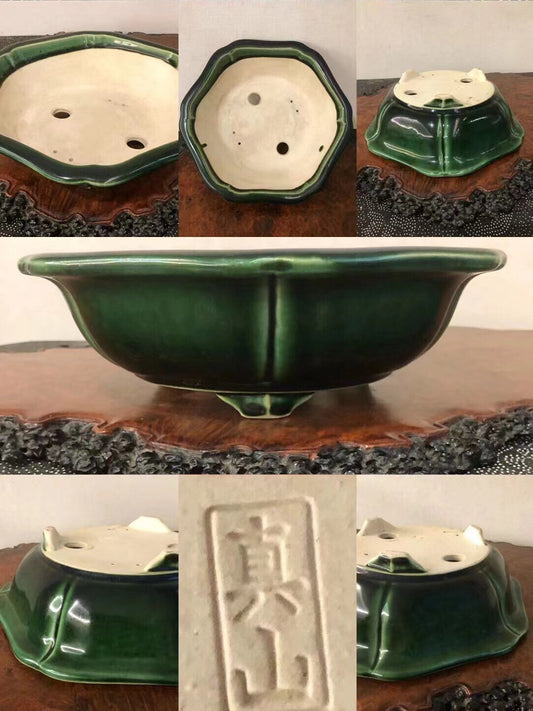 Dark green glazed ceramic bonsai pot with octagonal rim and three drainage holes.