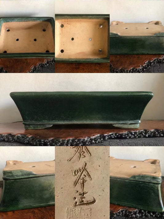 Dark green glazed rectangular pot with carved signature and drainage holes.