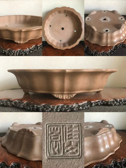 A matte brown ceramic bonsai pot with scalloped edges and a square seal impression.