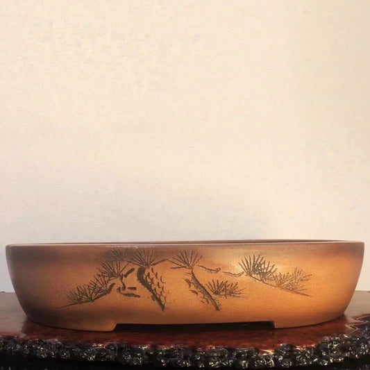 Six views of a brown glazed ceramic bonsai pot with carved pine tree and character decoration.