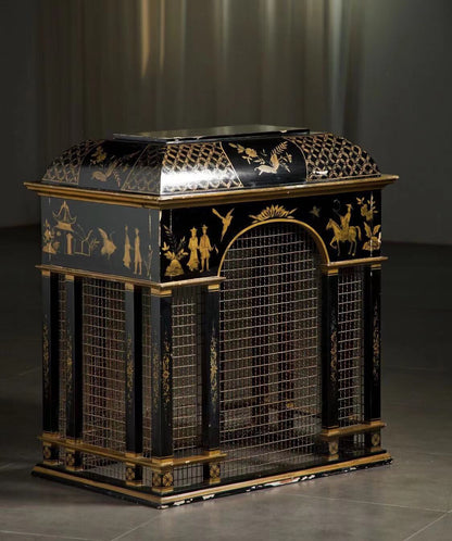 Black lacquered cabinet with gold painted scenes and wire mesh panels.