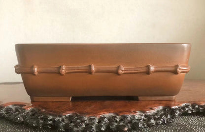 Rectangular brown glazed pot with raised bamboo-style bands around its rim.