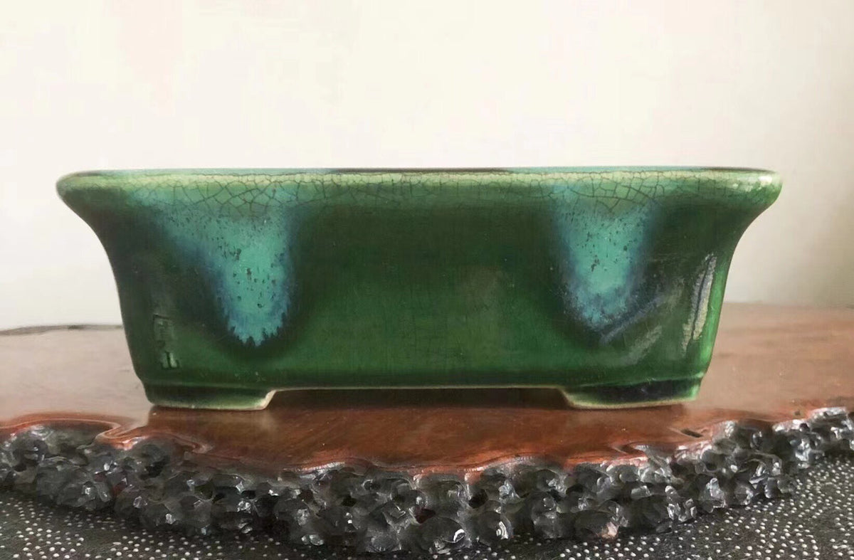 A rectangular green glazed pot with a crackled surface and subtle blue-green highlights.