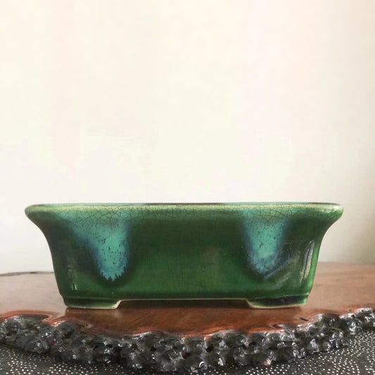 A rectangular green glazed pot with a crackled surface and subtle blue-green highlights.
