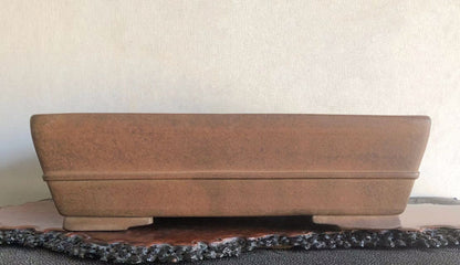 Rectangular terracotta pot with matte finish and two raised ridges along its sides.