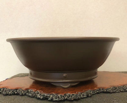 Dark brown glazed ceramic bonsai pot with a wide rim and a single central foot.