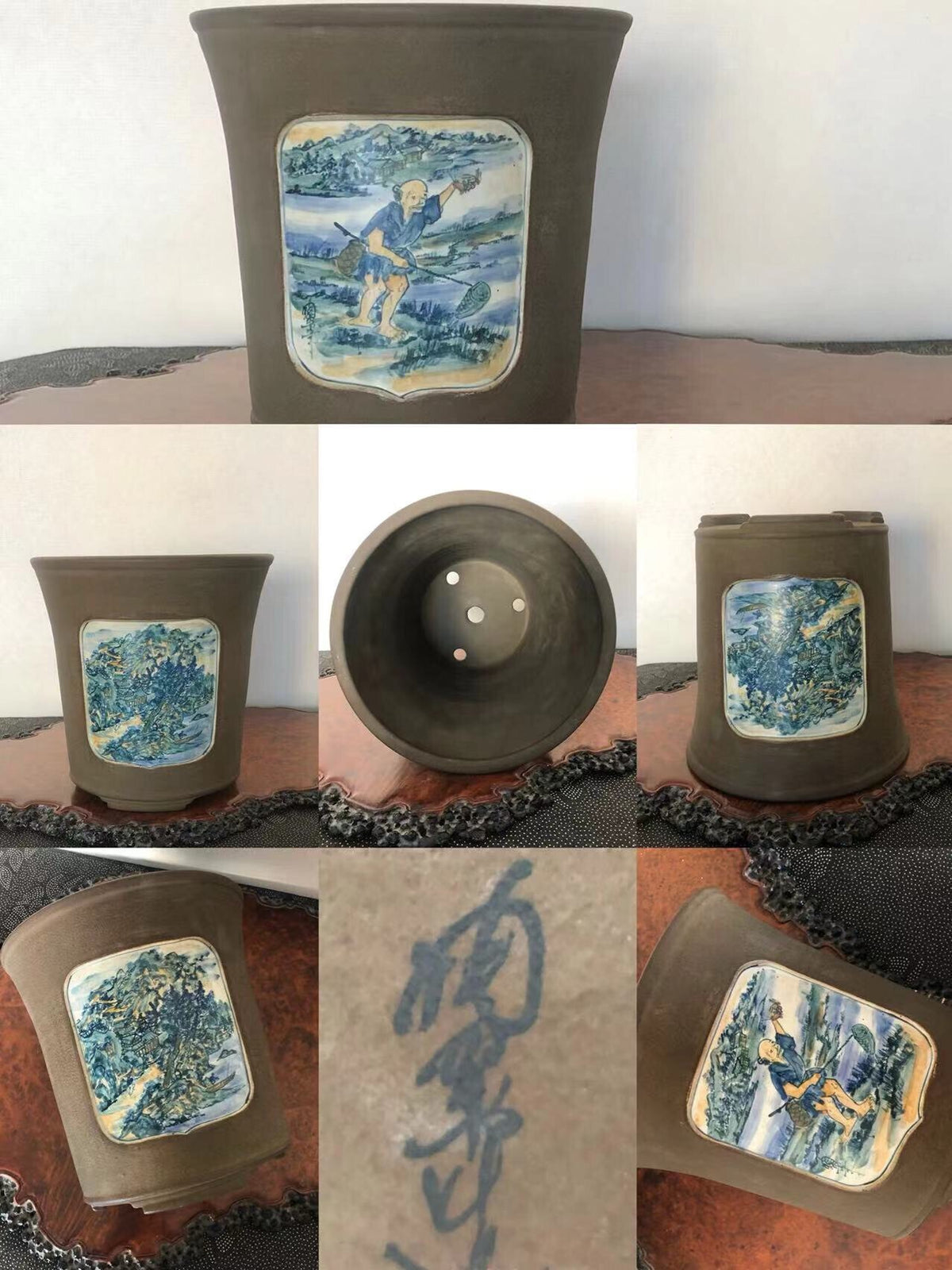 Dark brown ceramic pot with blue and white painted landscape panel on front.